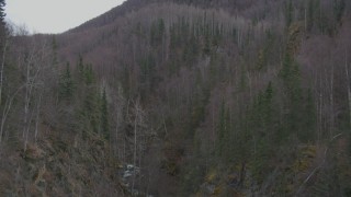 AK0001_0633 - 4K aerial stock footage flying above a river gorge, approaching wooded hills, Birchwood, Alaska