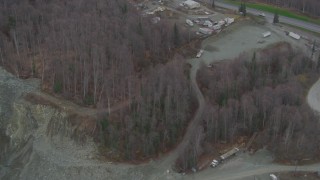 AK0001_0658 - 4K aerial stock footage flying over rock quarry, heavy equipment, wooded areas, Chugiak, Alaska