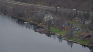 AK0001_0662 - 4K aerial stock footage fly by Lower Fire Lake, Glenn Highway, pan to homes, seaplanes, Chugiak, Alaska