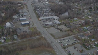 AK0001_0663 - 4K aerial stock footage Old Glenn Highway through town, tilt up to reveal shops, Eagle River, Alaska