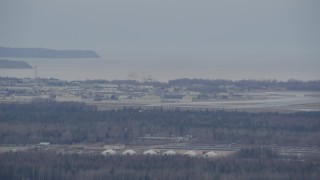 AK0001_0666 - 4K aerial stock footage tracking military jet approaching Elmendorf Air Force Base, Anchorage, Alaska