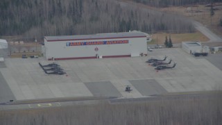 AK0001_0669 - 4K aerial stock footage flying by a helicopter taxiing at Bryant Army Heliport,  Anchorage, Alaska