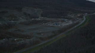 AK0001_0712 - 4K aerial stock footage flying by hillside rock quarry, Old Glenn Highway, winter, Chugiak, Alaska