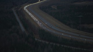 AK0001_0718 - 4K aerial stock footage approaching accident backing up traffic on Glenn Highway, Alaska, twilight
