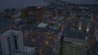 AK0001_0729 - 4K aerial stock footage flying by Hotel Captain Cook and office buildings in Downtown Anchorage, Alaska, sunset