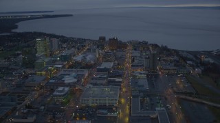 AK0001_0731 - 4K aerial stock footage West 6th Ave to West 3rd Ave, winter, Downtown Anchorage, Alaska, twilight