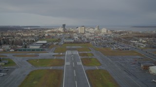 AK0001_0739 - 4K aerial stock footage ascend from Merrill Field, fly by Downtown Anchorage, Alaska