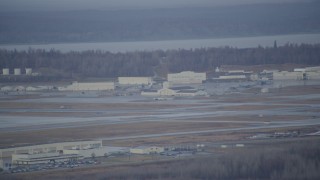 AK0001_0740 - 4K aerial stock footage flying by hangars, runway in winter, Elmendorf Air Force Base, Anchorage