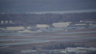 AK0001_0741 - 4K aerial stock footage a view of hangars, aircraft in winter, Elmendorf Air Force Base, Anchorage