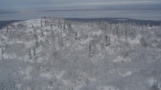 AK0001_0756 - 4K aerial stock footage fly over a snowy slope to reveal Chugiak, Chugach Mountains, Alaska
