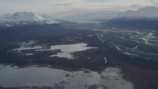 AK0001_0790 - 4K aerial stock footage tilt from Gull and Swan Lakes, reveal Knik Glacier, snowy Chugach Mountains, Knik River Valley, Alaska