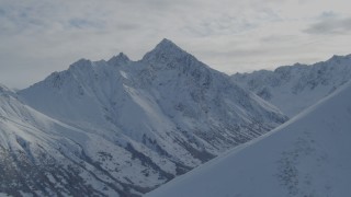 AK0001_0799 - 4K aerial stock footage approaching valley, snow-covered Chugach Mountains, Alaska
