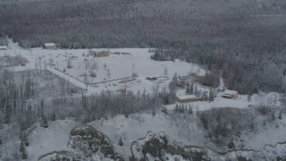 AK0001_0850 - 4K aerial stock footage flying by snowy King Ranch, forest, Sutton, Alaska
