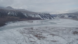 AK0001_0856 - 4K aerial stock footage flying along icy Matanuska River Valley, Alaska