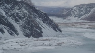 AK0001_0857 - 4K aerial stock footage descend toward the icy Matanuska River Valley, Alaska