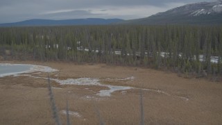 AK0001_0894 - 4K aerial stock footage fly over frozen rivers, ponds, forest during winter, Tazlina River Valley, Alaska