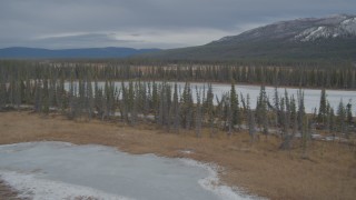AK0001_0895 - 4K aerial stock footage fly over frozen rivers, ponds, and forest in winter, Tazlina River Valley, Alaska