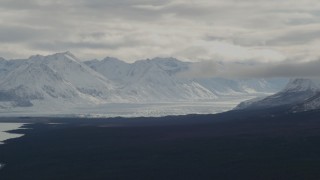 AK0001_0910 - 4K aerial stock footage Tazlina Glacier in snow-covered Chugach Mountains near Tazlina Lake, Alaska