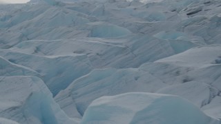 AK0001_0921 - 4K aerial stock footage flying over snow covered surface of the Tazlina Glacier, Alaska