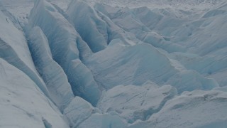AK0001_0922 - 4K aerial stock footage flying over snow covered surface of the Tazlina Glacier, Alaska