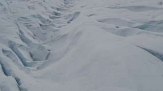 AK0001_0923 - 4K aerial stock footage flying over snow covered surface of the Tazlina Glacier, Alaska
