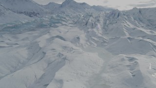 AK0001_0925 - 4K aerial stock footage flying over snow covered surface of the Tazlina Glacier, Alaska