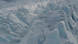 AK0001_0926 - 4K aerial stock footage flying over snow covered surface of the Tazlina Glacier, Alaska