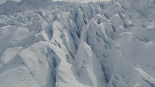 AK0001_0928 - 4K aerial stock footage flying over snow covered surface of the Tazlina Glacier, Alaska