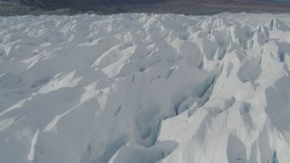 AK0001_0932 - 4K aerial stock footage flying over snow covered surface of the Tazlina Glacier, Alaska