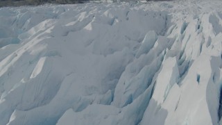AK0001_0933 - 4K aerial stock footage flying over snow covered surface of the Tazlina Glacier, Alaska