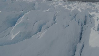 AK0001_0934 - 4K aerial stock footage flying over snow covered surface of the Tazlina Glacier, Alaska