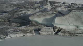 AK0001_0937 - 4K aerial stock footage flying low over the dirty, snowy edge of Tazlina Glacier, Alaska