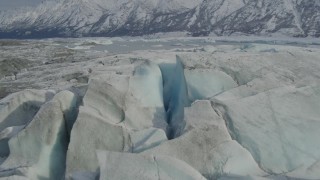 AK0001_0938 - 4K aerial stock footage approaching Tazlina Lake, during winter, over icy, snow covered surface of Tazlina Glacier, Alaska