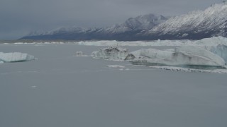 AK0001_0943 - 4K aerial stock footage flying near edge of snow covered glacier, during winter, over Tazlina Lake, Alaska