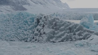 AK0001_0945 - 4K aerial stock footage orbiting glacial ice, in snow, during winter, Tazlina Lake, Alaska