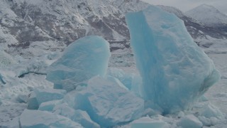 AK0001_0947 - 4K aerial stock footage fly by glacial ice near edge of glacier, during winter, in snow, Tazlina Lake, Alaska