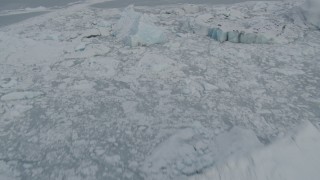 AK0001_0948 - 4K aerial stock footage flying over snow covered glacier edge and Tazlina Lake during winter, Tazlina Glacier, Alaska