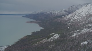 AK0001_0950 - 4K aerial stock footage approaching snow-capped Chugach Mountains, flying by Tazlina Lake, Alaska