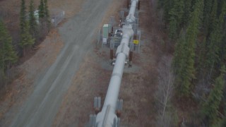 AK0001_0978 - 4K aerial stock footage following pipeline through forest, during winter, Trans-Alaska Pipeline, Alaska