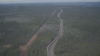 AK0001_0983 - 4K aerial stock footage flying over pipeline, revealing forest during winter, Trans-Alaska Pipeline, Alaska