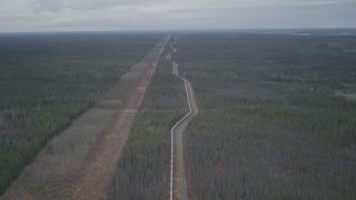 AK0001_0994 - 4K aerial stock footage follow pipeline through forest, during winter, Trans-Alaska Pipeline, Alaska