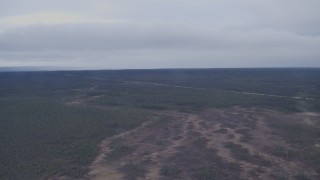 AK0001_1020 - 4K aerial stock footage Glenn Highway running through forest in the Alaskan Wilderness