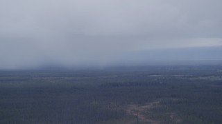 AK0001_1021 - 4K aerial stock footage flying away from low clouds over forest, Alaskan Wilderness