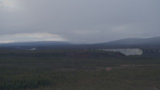AK0001_1040 - 4K aerial stock footage flying over forest near a canyon, Alaskan Wilderness