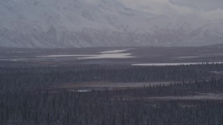 AK0001_1052 - 4K aerial stock footage Lake Leila and Trail Lake at base of snow covered Chugach Mountains, Alaska
