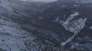 AK0001_1064 - 4K aerial stock footage snow covered wooded hills, river through valley, Talkeetna Mountains, Alaska