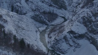 AK0001_1066 - 4K aerial stock footage following a river in a snow covered canyon, Talkeetna Mountains, Alaska