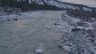 AK0001_1075 - 4K aerial stock footage following the Matanuska River and snow covered shore, Alaska