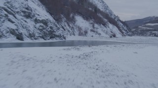 AK0001_1082 - 4K aerial stock footage racing low over surface of Matanuska River in snow covered ground, Alaska