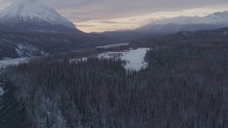 AK0001_1104 - 4K aerial stock footage approach King Ranch, landing on snow near airplanes, Sutton, Alaska, twilight